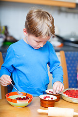 Image showing Cute boy making cupcakes