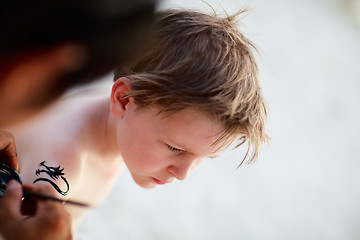 Image showing Boy having henna tattoo