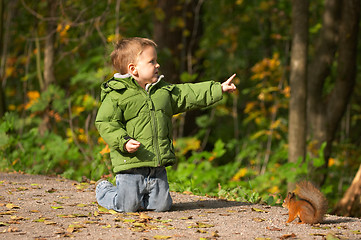 Image showing Little boy and squirrel