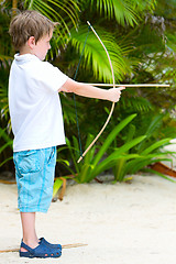 Image showing Cute boy playing with bow and arrows