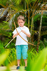 Image showing Cute boy playing with bow and arrows