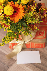 Image showing  giftbox and a bouquet of flowers 