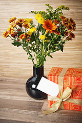 Image showing  giftbox and a bouquet of flowers 