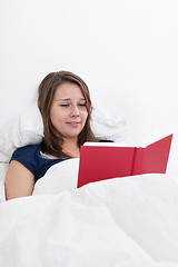 Image showing Woman reading in bed