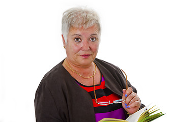 Image showing Female senior reading a book