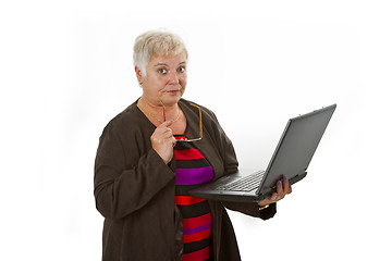 Image showing Skeptic female senior with laptop