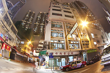 Image showing Hong Kong downtown at night - old apartments and modern building