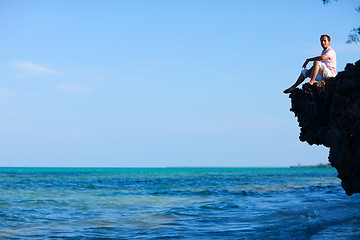 Image showing Man sitting on rock