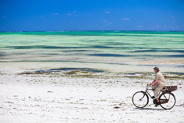 Image showing Man biking at beach