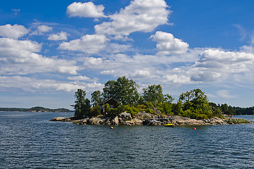 Image showing Swedish red cottage on a small island