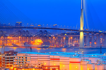 Image showing gas tank and highway bridge