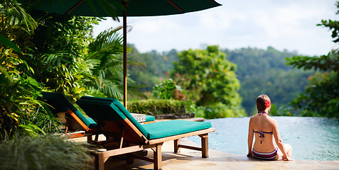 Image showing Woman relaxing at swimming pool