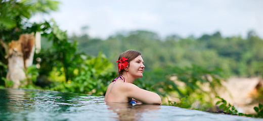 Image showing Woman relaxing at swimming pool