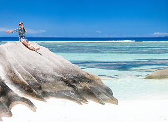 Image showing Woman sitting on top of granite rock