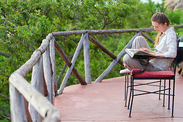 Image showing Woman reading outdoors