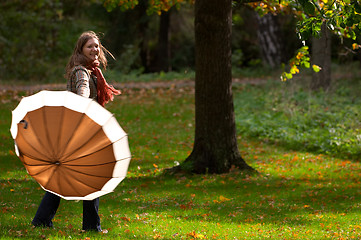 Image showing Young woman with umbrella