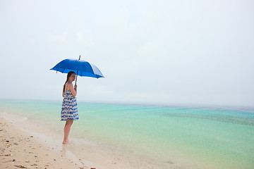 Image showing Woman at beach under rain