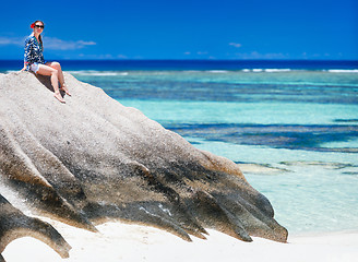 Image showing Woman sitting on top of granite rock