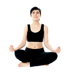 Image showing Youung woman meditating in lotus pose