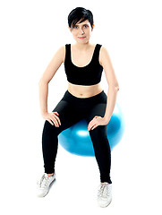 Image showing Fitness woman isolated sitting on pilate ball