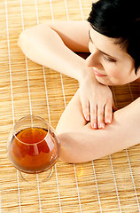 Image showing Spa woman relaxing with a wine glass beside her