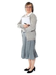 Image showing Full length portriat of an aged woman carrying business documents