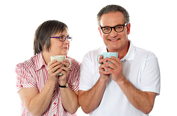 Image showing Romantic senior couple holding coffee mugs