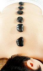 Image showing Naked woman getting spa hot stone treatment