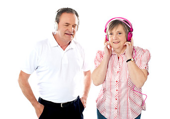 Image showing Happy aged couple enjoying music together