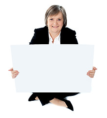 Image showing Corporate lady sitting on floor with a blank billboard