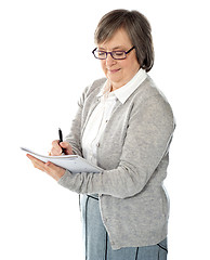 Image showing Portrait of a businesswoman writing notes