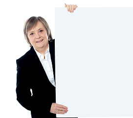 Image showing Female executive holding blank whiteboard