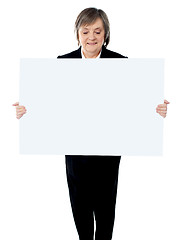 Image showing Portrait of a business lady holding a blank billboard