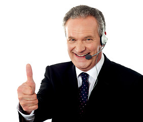 Image showing Call centre executive smiling with thumbs-up