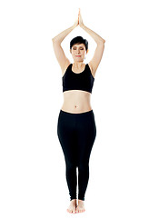 Image showing Full-length view of fit woman doing yoga