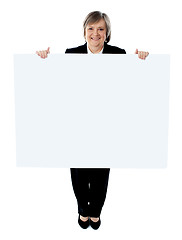 Image showing Businesswoman holding a blank poster