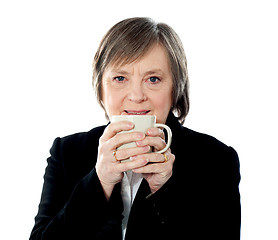 Image showing Old woman holding coffee mug