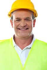 Image showing Smiling senior builder wearing hardhat