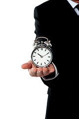 Image showing Cropped image of a man with alarm clock on his palm