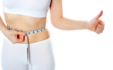 Image showing Closeup of tape measure around woman waist