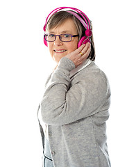 Image showing Aged woman enjoying music