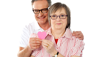 Image showing Matured smiling couple holding paper heart