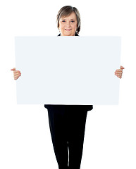 Image showing Female executive standing with a blank billboard
