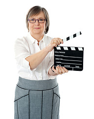 Image showing Attractive senior woman using clapperboard