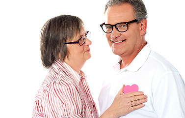 Image showing Senior couple with pink heart isolated on white