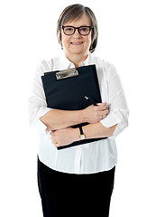 Image showing Portrait of senior businesswoman holding reports