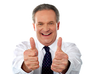 Image showing Happy businessman gesturing double thumbs-up