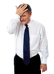 Image showing Sad old corporate man with hand on head