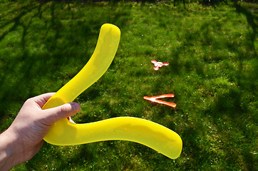 Image showing Hand hold boomerang thrown flying toy play outside 