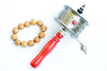 Image showing Tibetan prayer wheel and beads on a white background